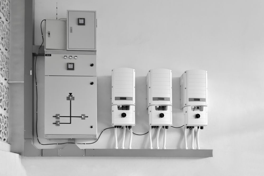 A Black And White Photo Of A Row Of Electrical Boxes On A Wall — Trusted Energy Solutions In Everton Hills, QLD