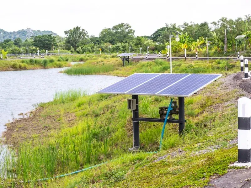 A Solar Panel Is Sitting Next To A Body Of Water — Trusted Energy Solutions In Ferny, QLD