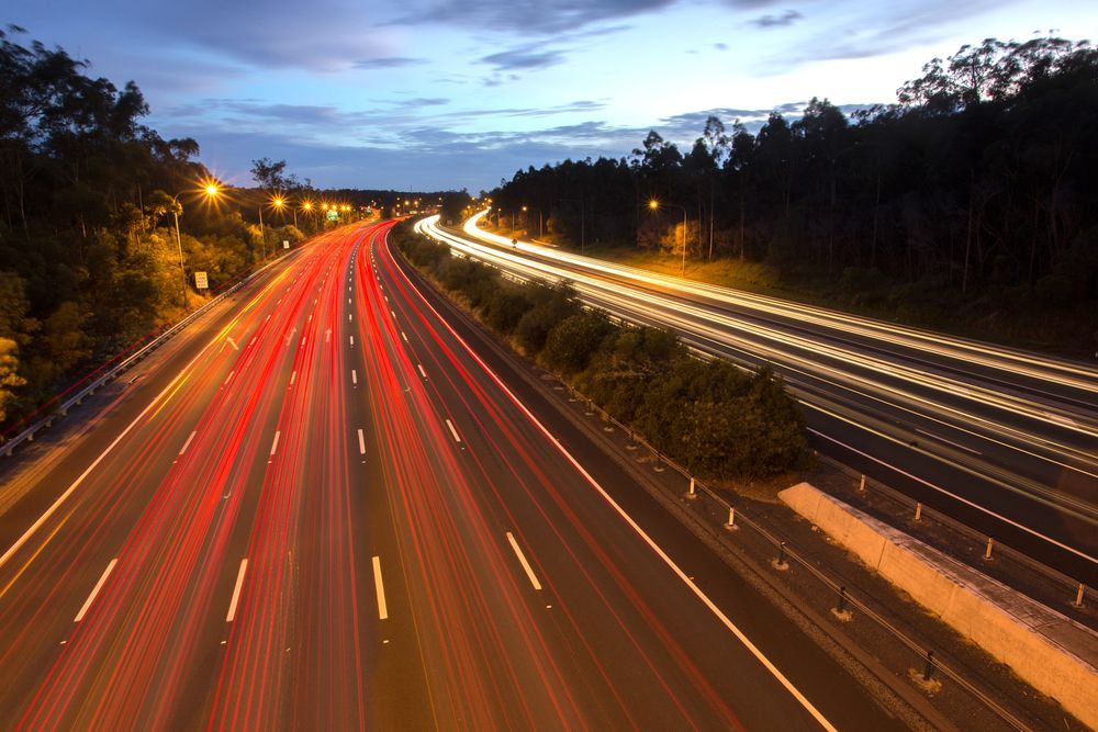 A Long Exposure Photo Of A Highway At Night — Trusted Energy Solutions In Upper Coomera, QLD