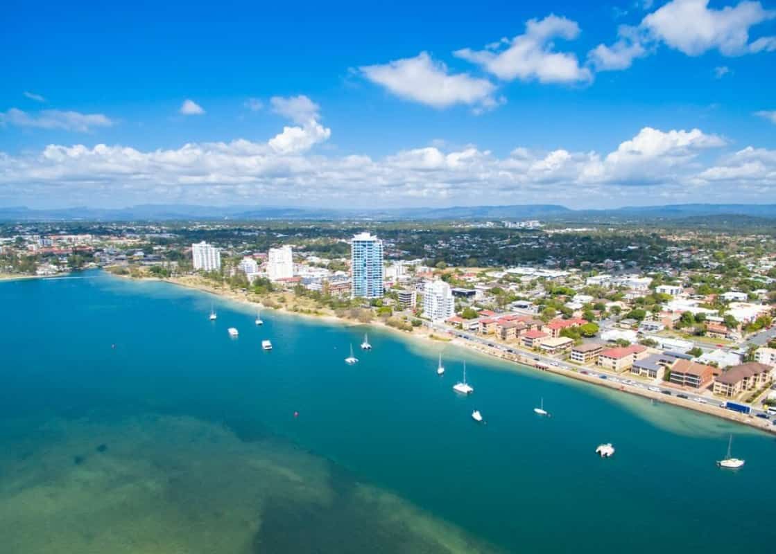An Aerial View of a City Next to a Body of Water — Trusted Energy Solutions In Labrador, QLD