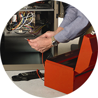 Hands working inside an open computer case beside a red toolbox
