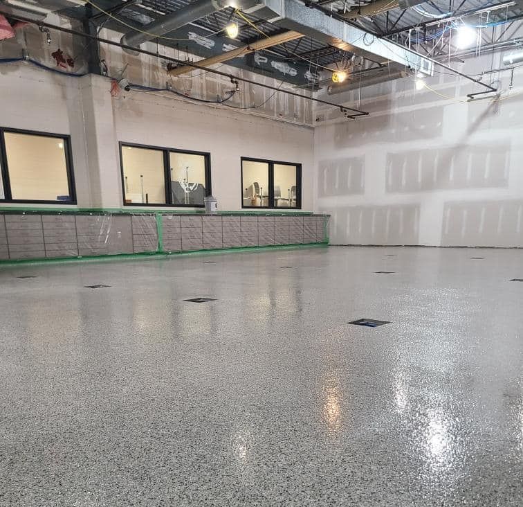 A large room with a lot of windows and a shiny floor