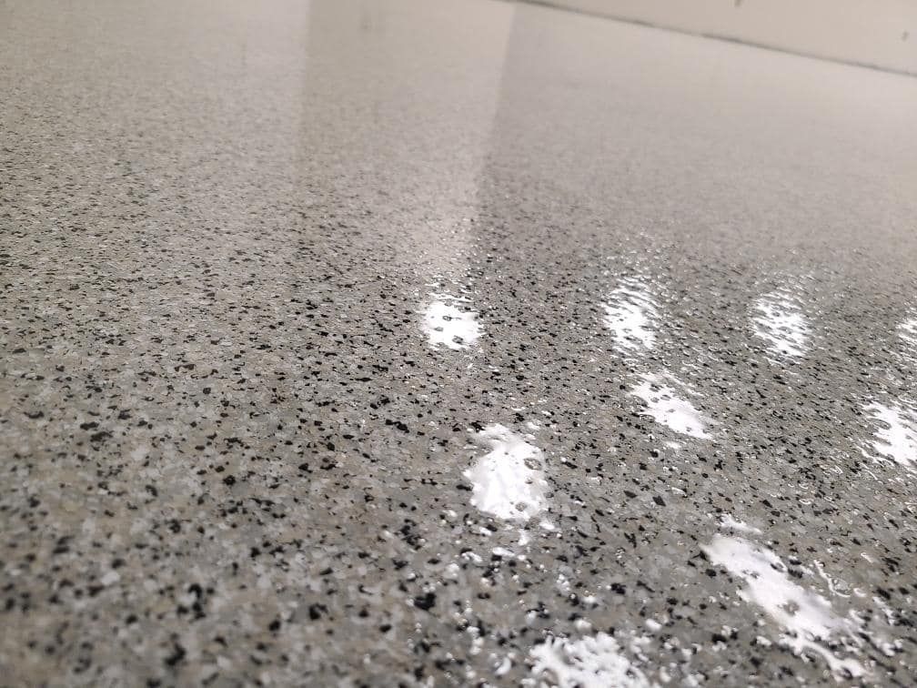 A close up of a shiny concrete floor in a room.
