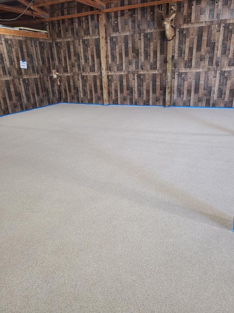 A room with a deer head on the wall and a carpeted floor.