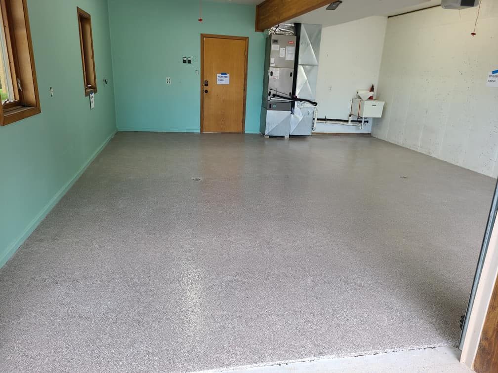 A lobby with a shiny concrete floor and a bench