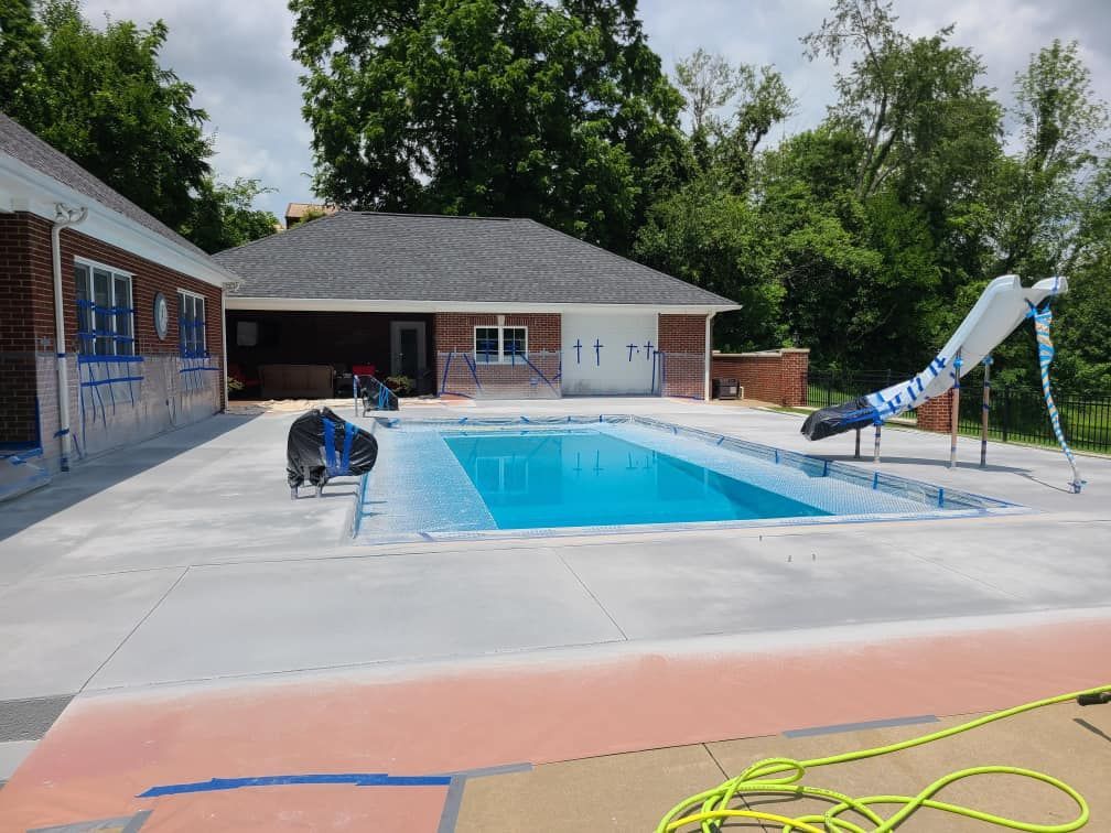 A swimming pool is being built in the backyard of a house