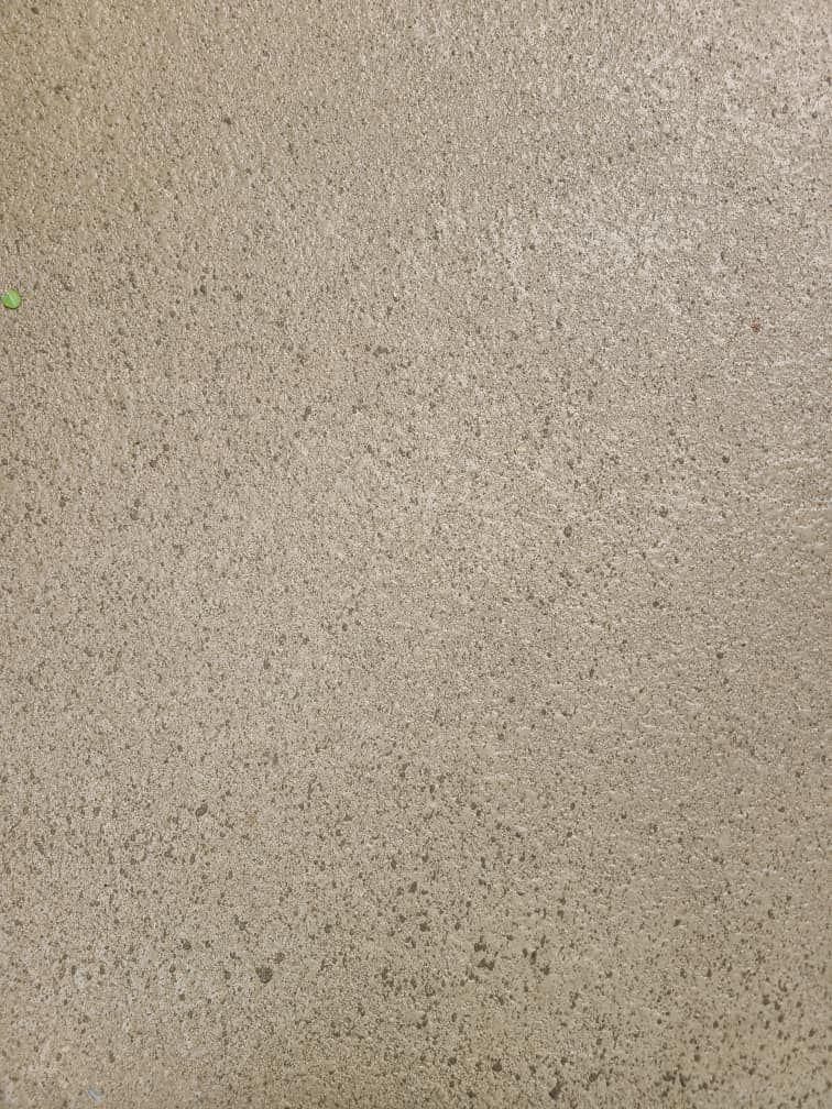 A close up of a concrete floor with a grainy texture.