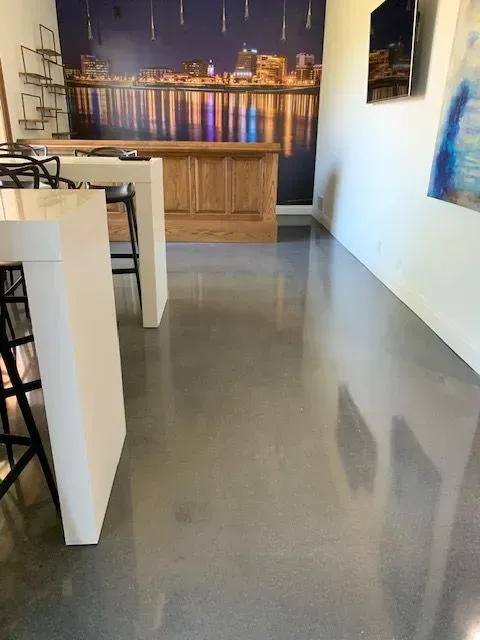 A room with a bar and a painting on the wall