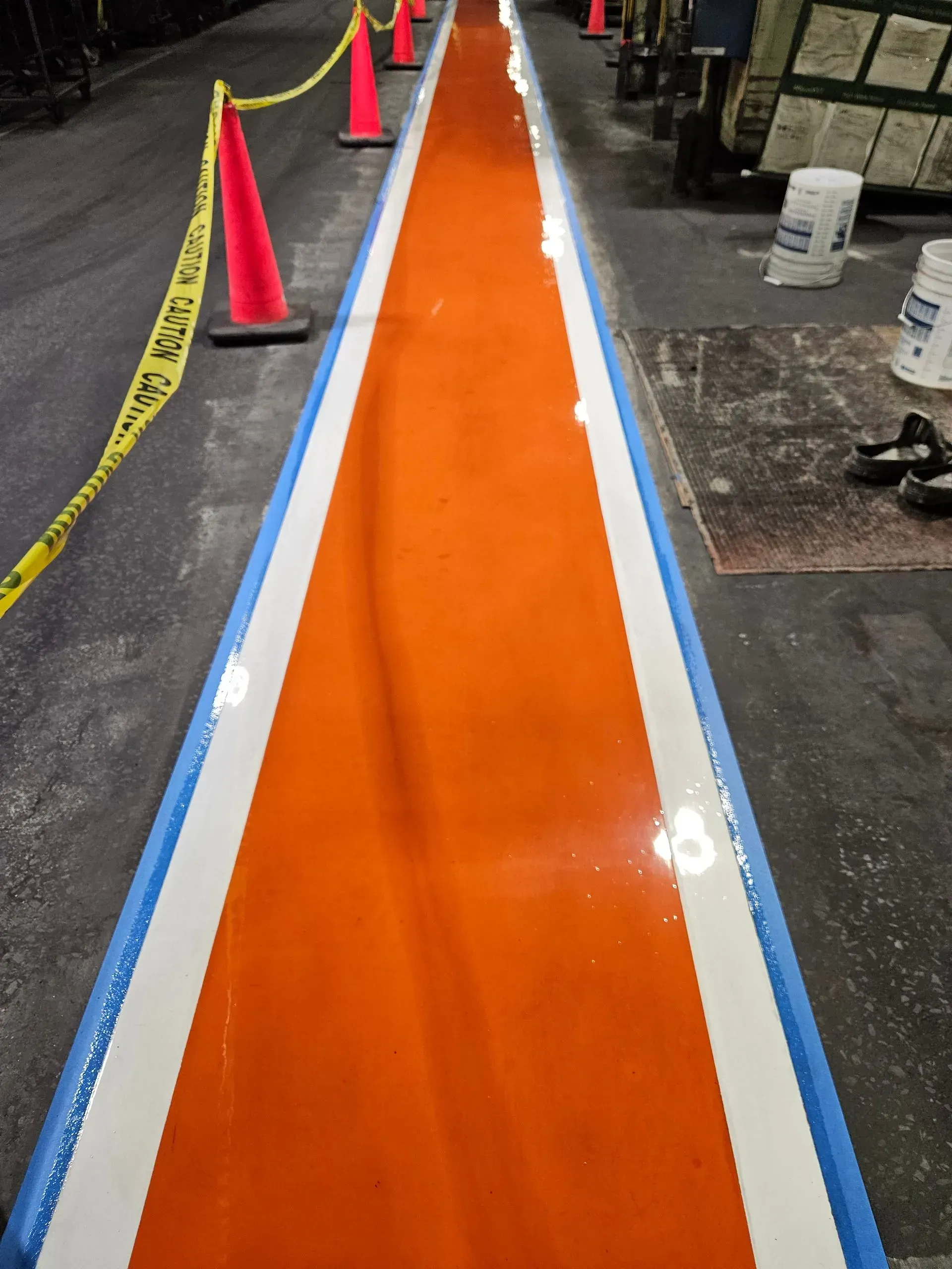 A row of orange and white cones on the side of a road