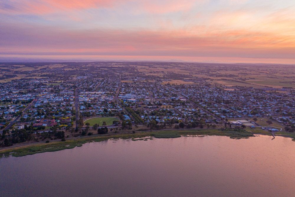 An Aerial View of a City and a Lake at Sunset — Ocean Grove Removals In Colac, VIC