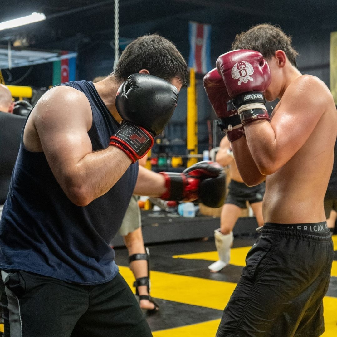 Adults and kids training striking and grappling at Killer B Combat Academy in Oakhurst, N.