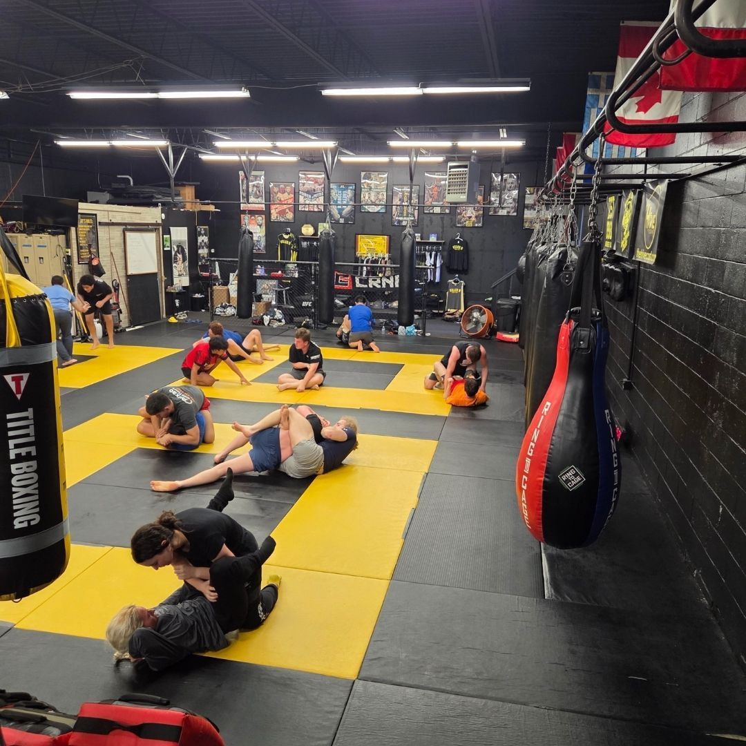 Adults and kids training practical self-defense drills at Killer B Combat Academy in Oakhurst, New Jersey for confidence.