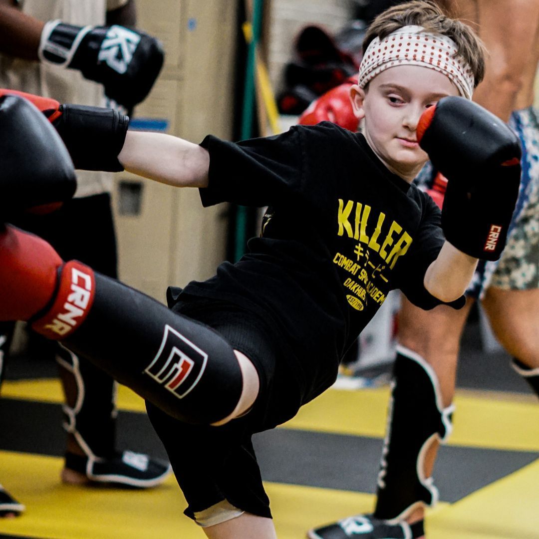 Students train MMA and grappling at Killer B Combat Academy in Oakhurst, NJ, building strength.