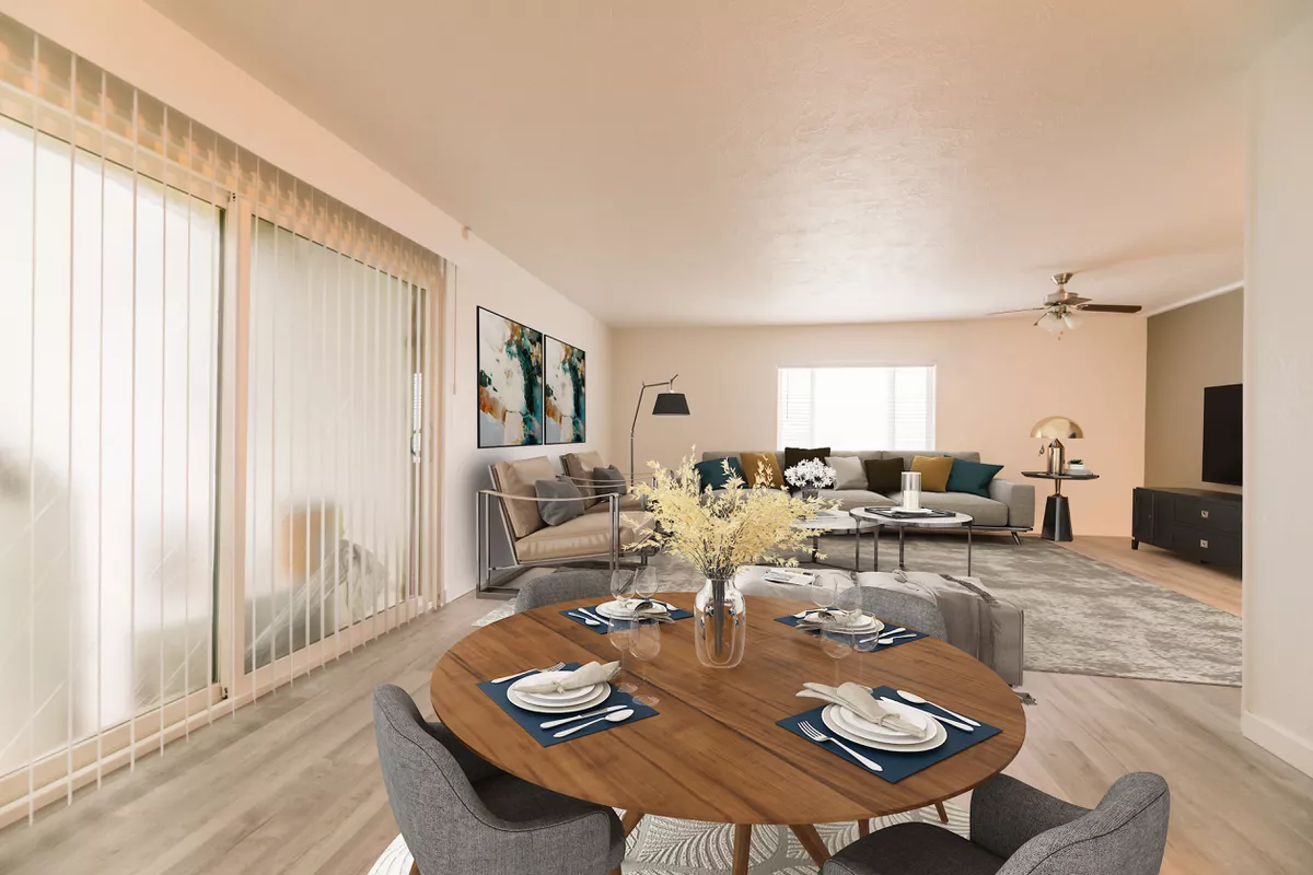 A living room with a dining table and chairs and a couch.