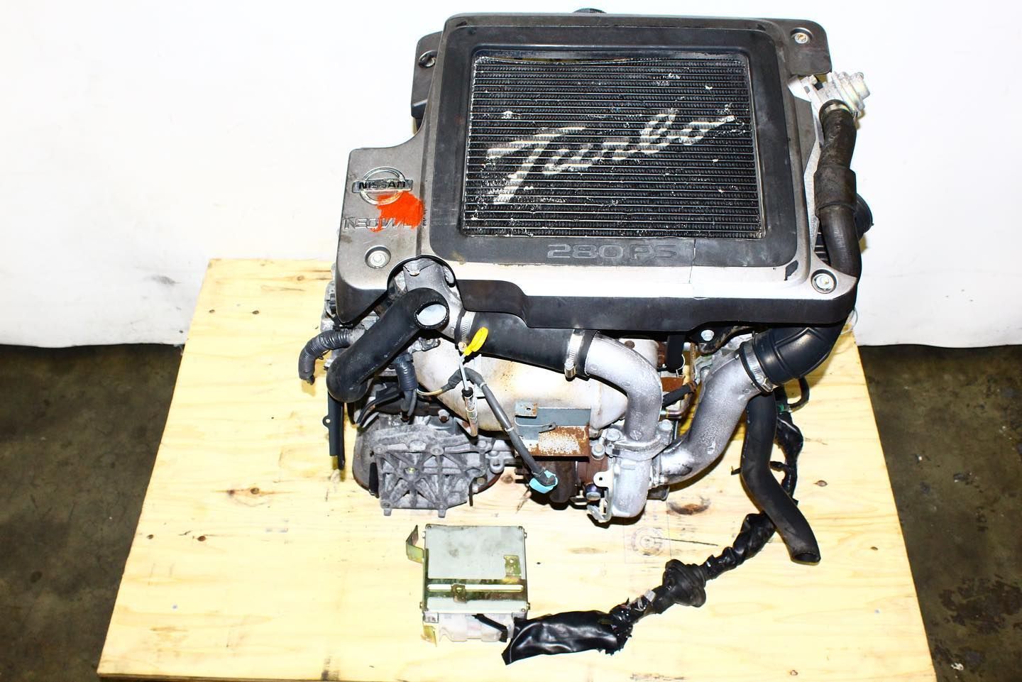 A bunch of gold pieces are sitting on a wooden pallet