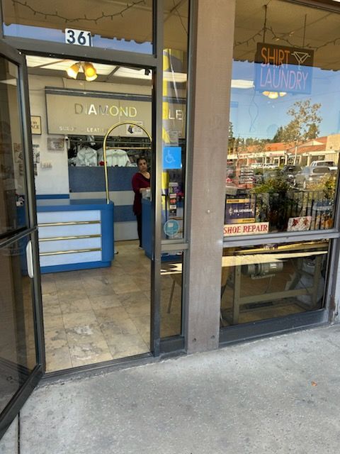 Diamond Clean dry cleaner storefront, blue and white facade.