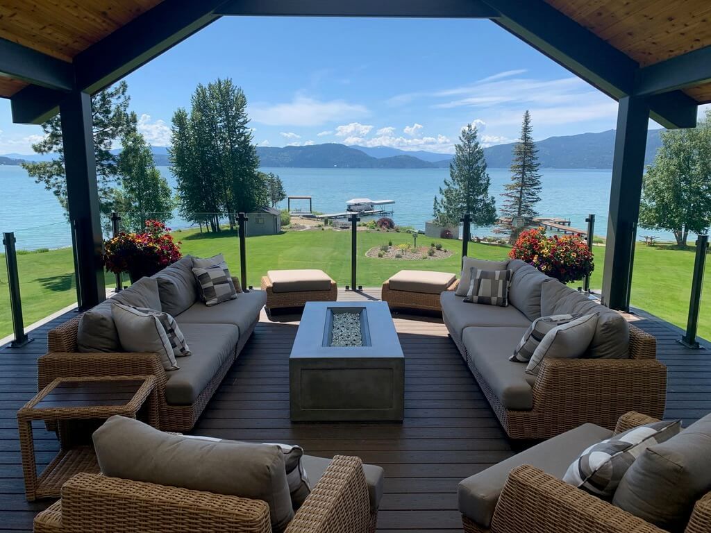 There is a fire pit on the deck with a view of the lake.