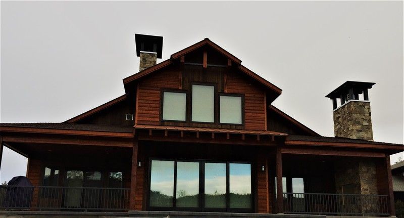 A large house with a lot of windows and a chimney