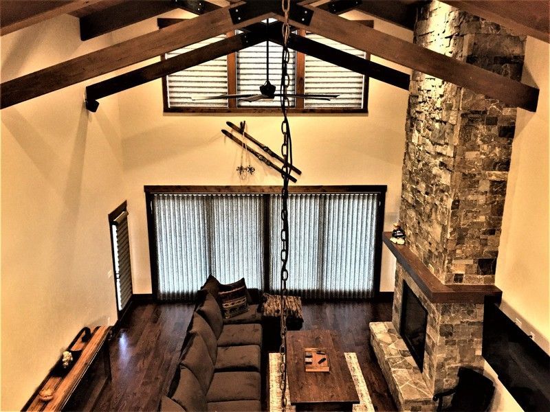 An aerial view of a living room with a stone fireplace