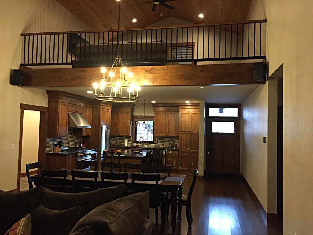 A living room with a couch , table , chairs and a balcony.