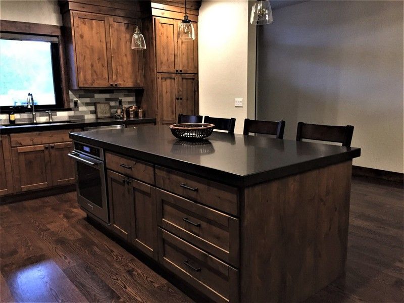 A kitchen with a large island and wooden cabinets