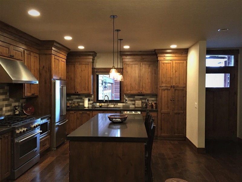 A kitchen with wooden cabinets and stainless steel appliances