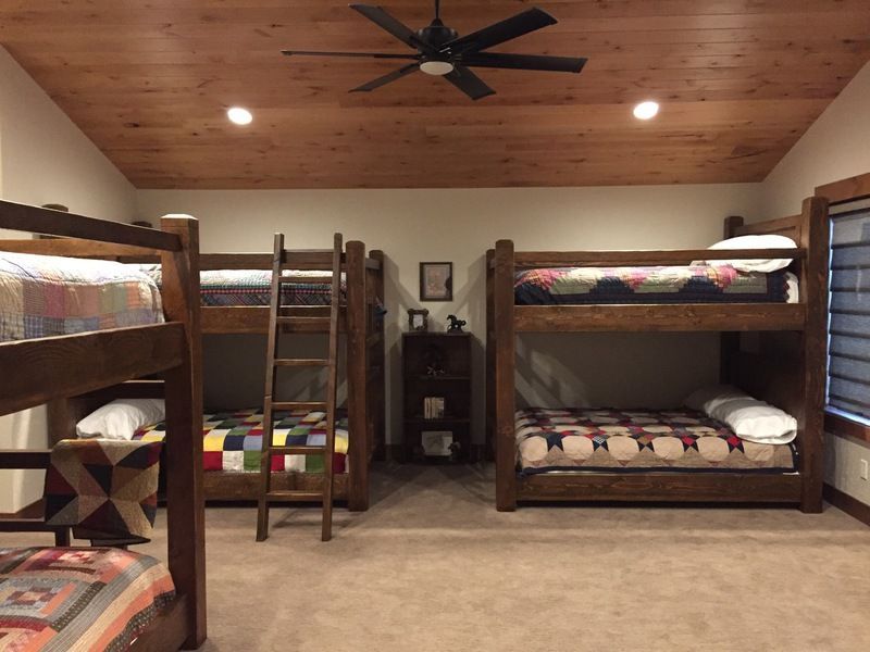 A room with bunk beds and a ceiling fan