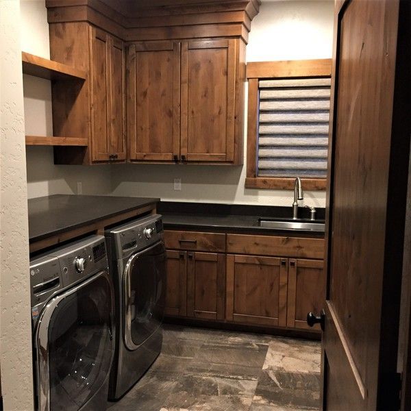 A laundry room with a washer and dryer and a sink