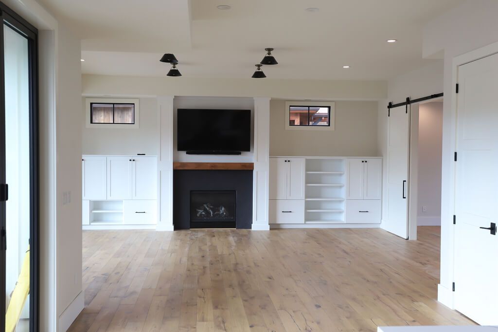 A living room with a fireplace and a flat screen tv