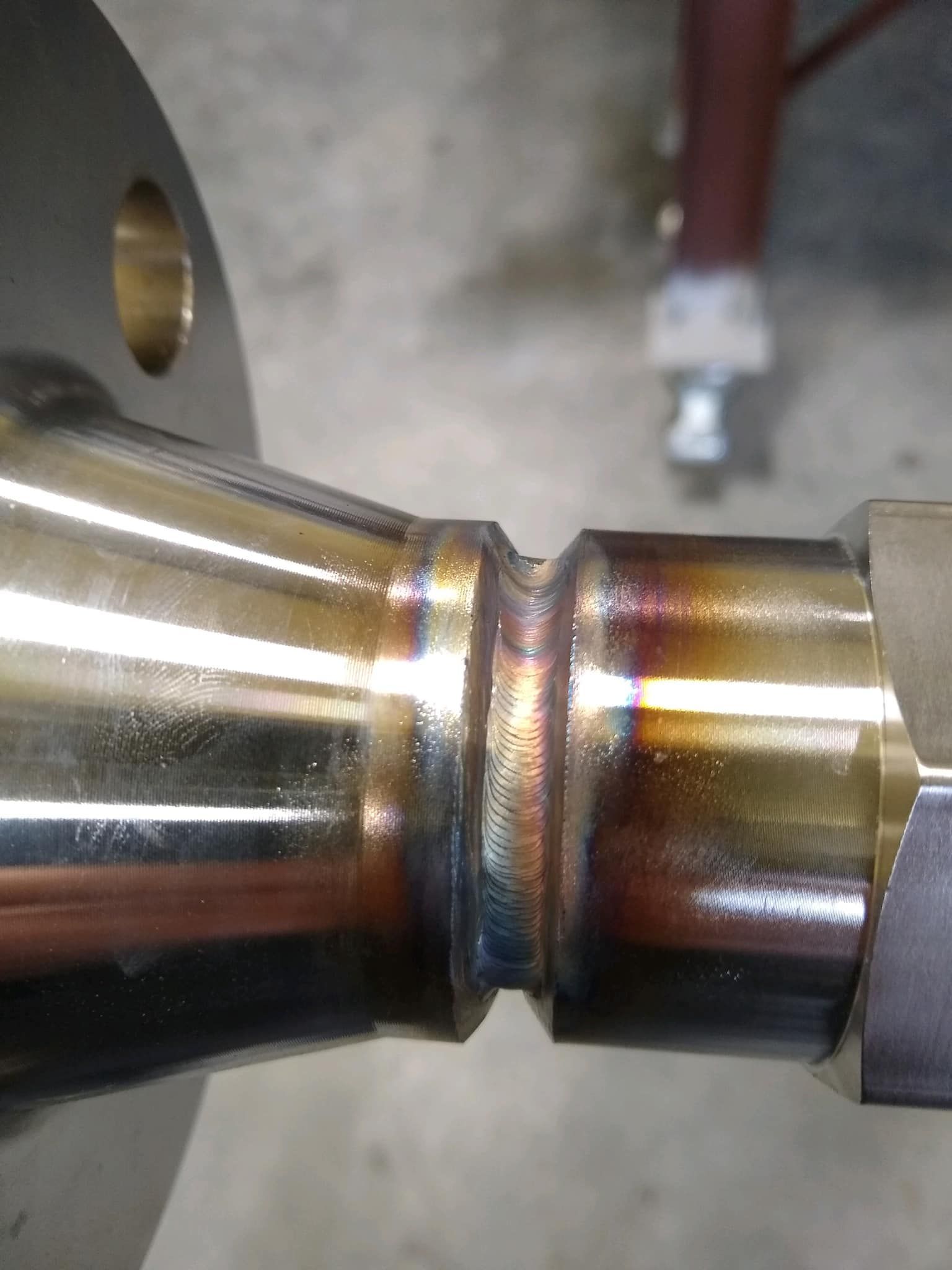 Welded stainless steel pipe sections with a flange and a fitting