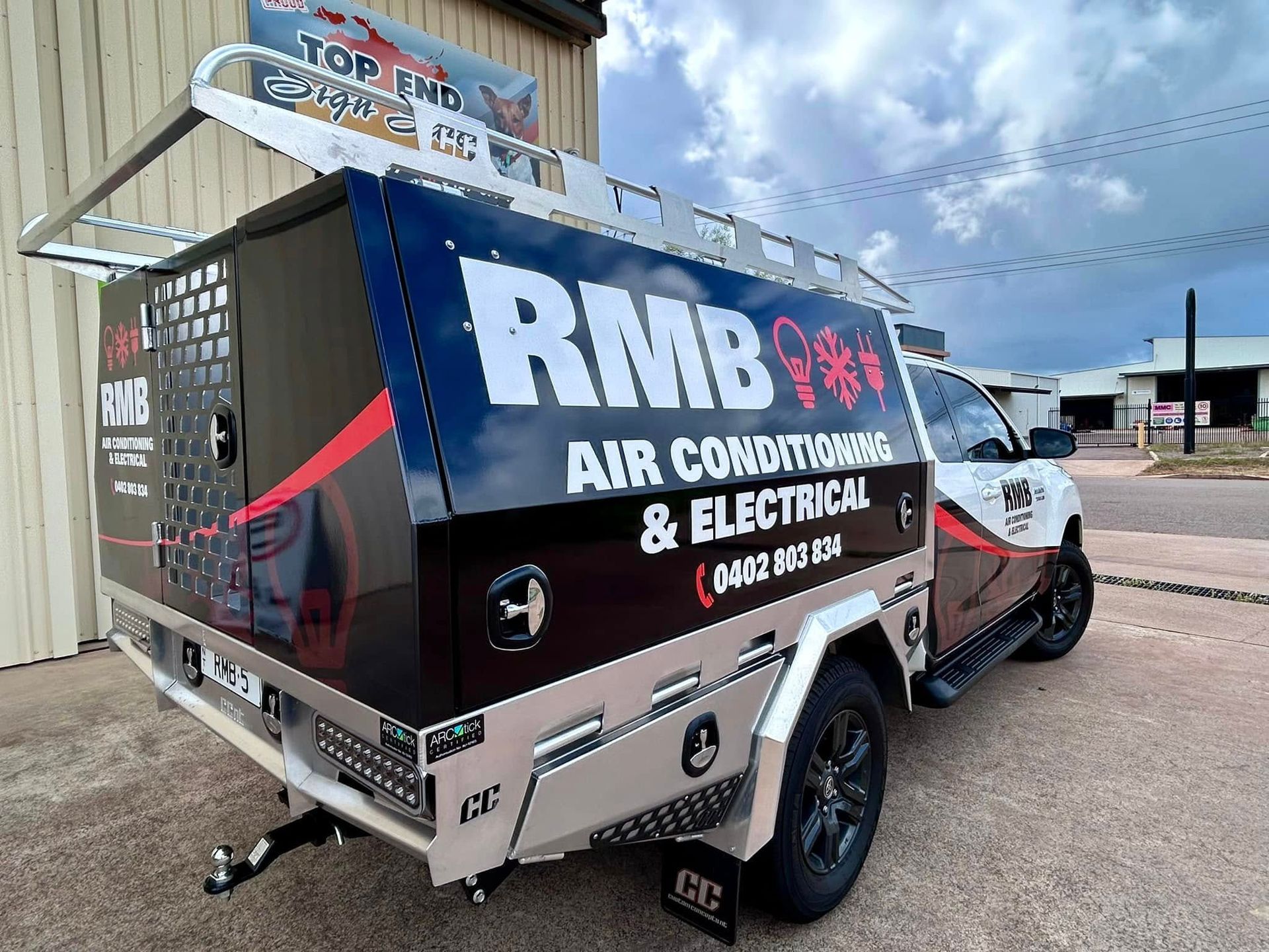 RMB Air Conditioning & Electrical truck. Black and silver truck with logo, red accents, and a roof rack — RMB Air Conditioning & Electrical in Winnellie, NT
