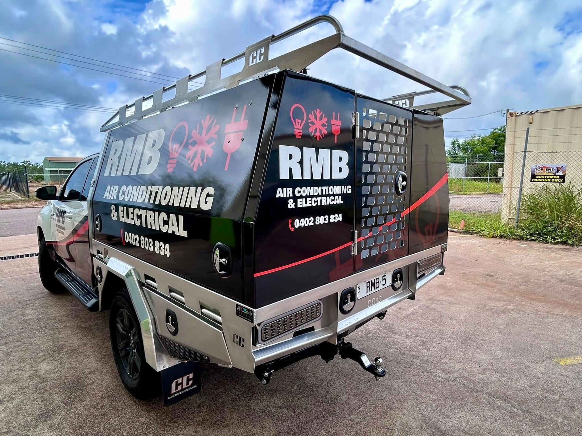 Black and silver RMB Air Conditioning & Electrical service truck with roof rack parked outside — RMB Air Conditioning & Electrical in Winnellie, NT