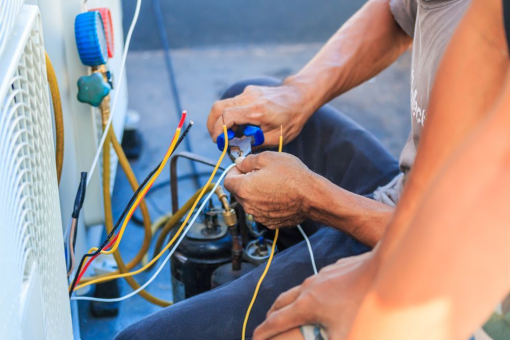 Technician Repairing Air Conditioner, Working with Wires — RMB Air Conditioning & Electrical in Winnellie, NT