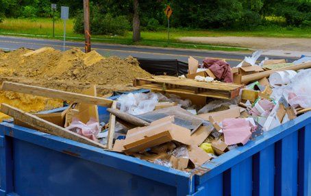 Waste Management — Dumpsters With Full Of Scraps In Louisville, KY