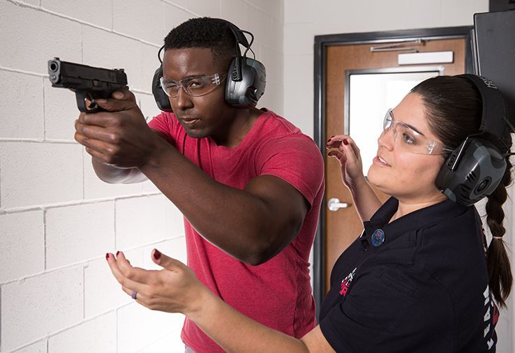 Laurie Green teaching a man how to shoot