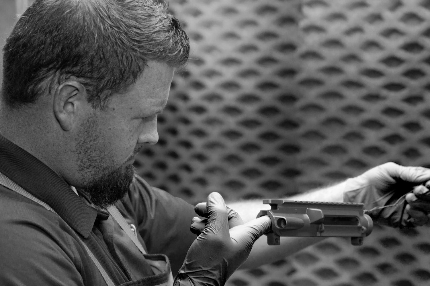 Gunsmith inspecting a gun