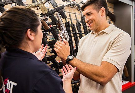 Employee showing a customer a gun