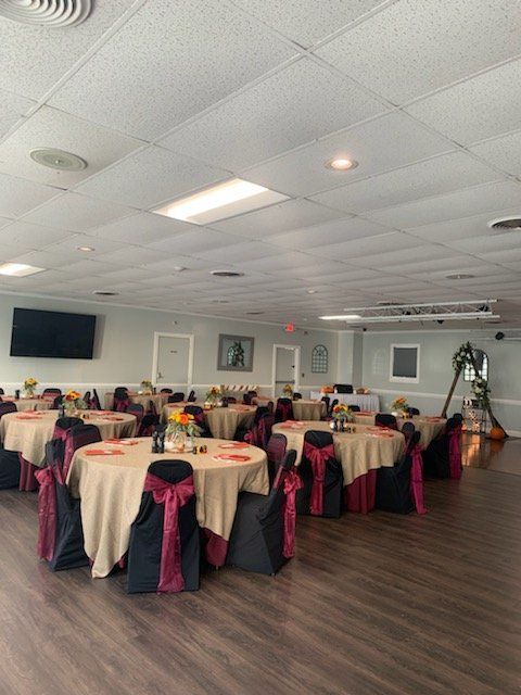 A large room with tables and chairs set up for a party