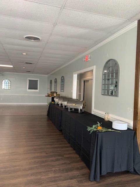 A large room with tables and buffets in it.