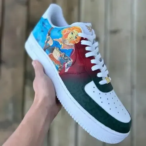 A person is holding a pair of shoes with a picture on them