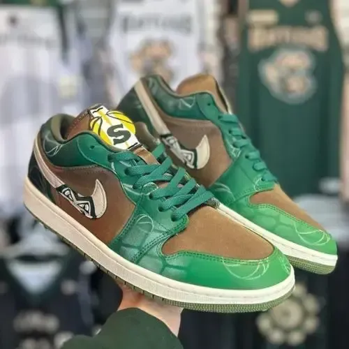 A person is holding a pair of green and brown Nike air jordan 1 low sneakers