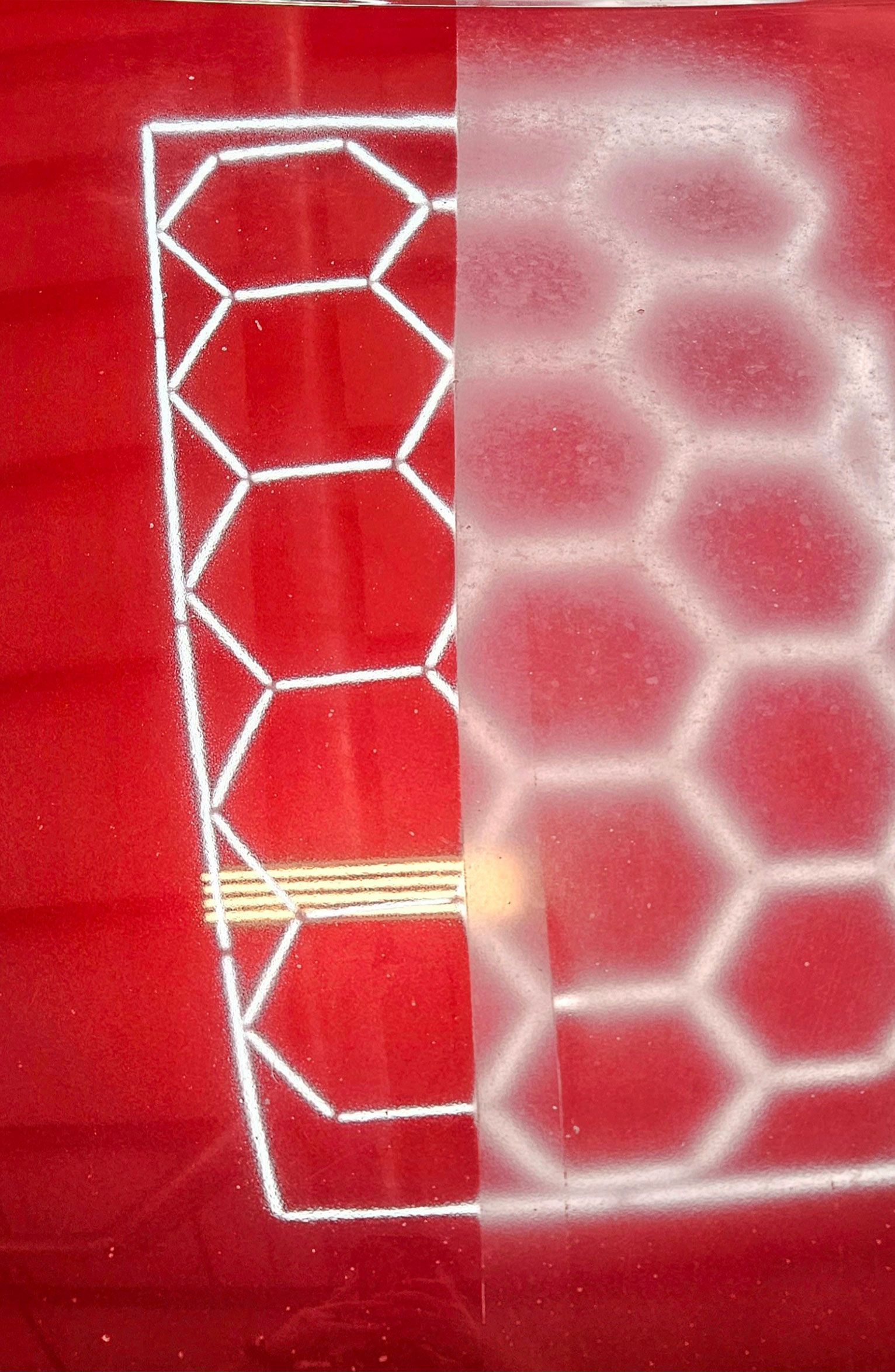 Green BMW M3 car covered in soapy foam, inside a garage.