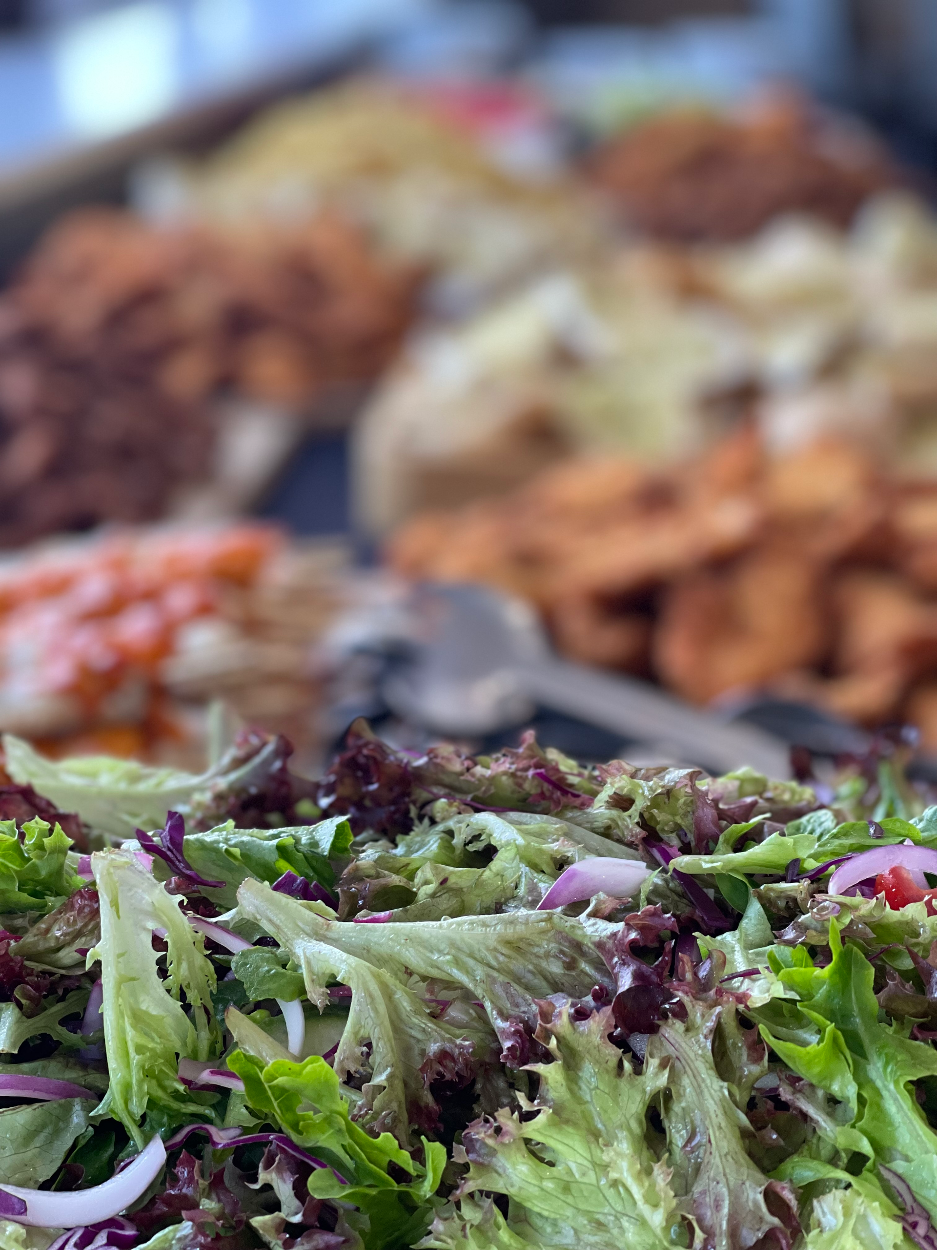 a close up of a salad on a buffet table .