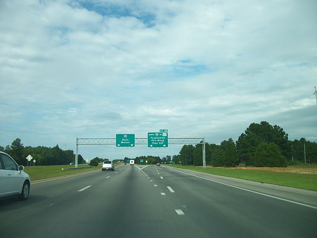 An aerial view of a busy highway intersection in a city.