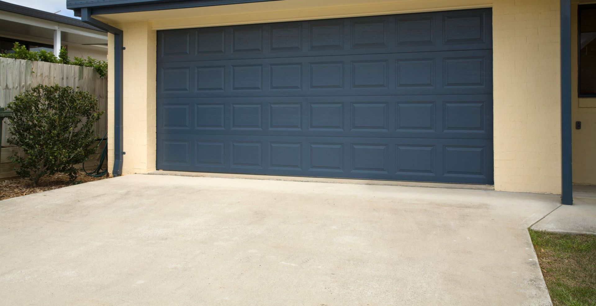 House with Blue Garage Doors — Dearborn, MI — Doors Are Us