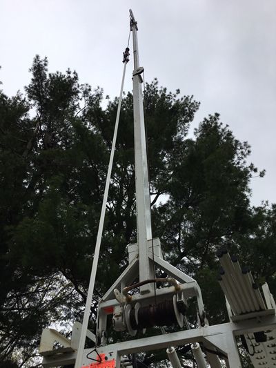 A Large Crane Is Sitting In Front Of A Tree - Lambertville, NJ - Mr. Well Pump
