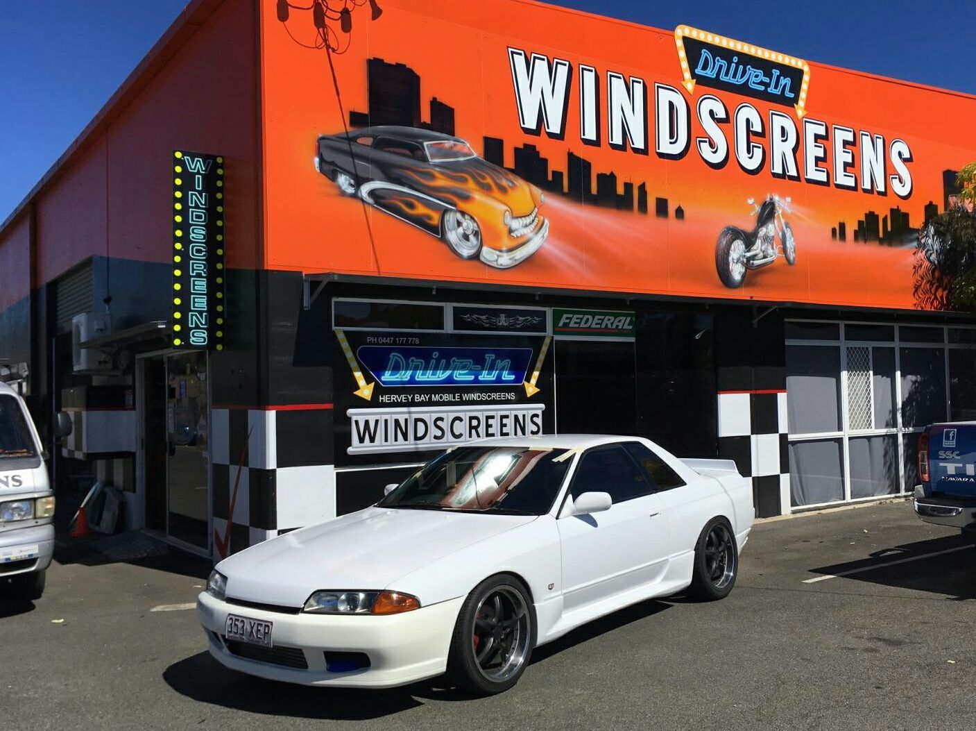 White Car Parked in Front of a Drive-in Windscreens — Hervey Bay Mobile Windscreens in Pialba, QLD