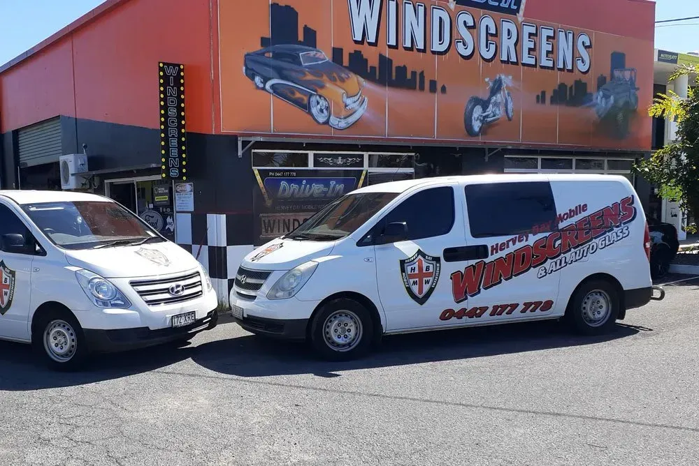 Two White Vans Parked Outside a Windscreen Business with Logo — Hervey Bay Mobile Windscreens in Pialba, QLD