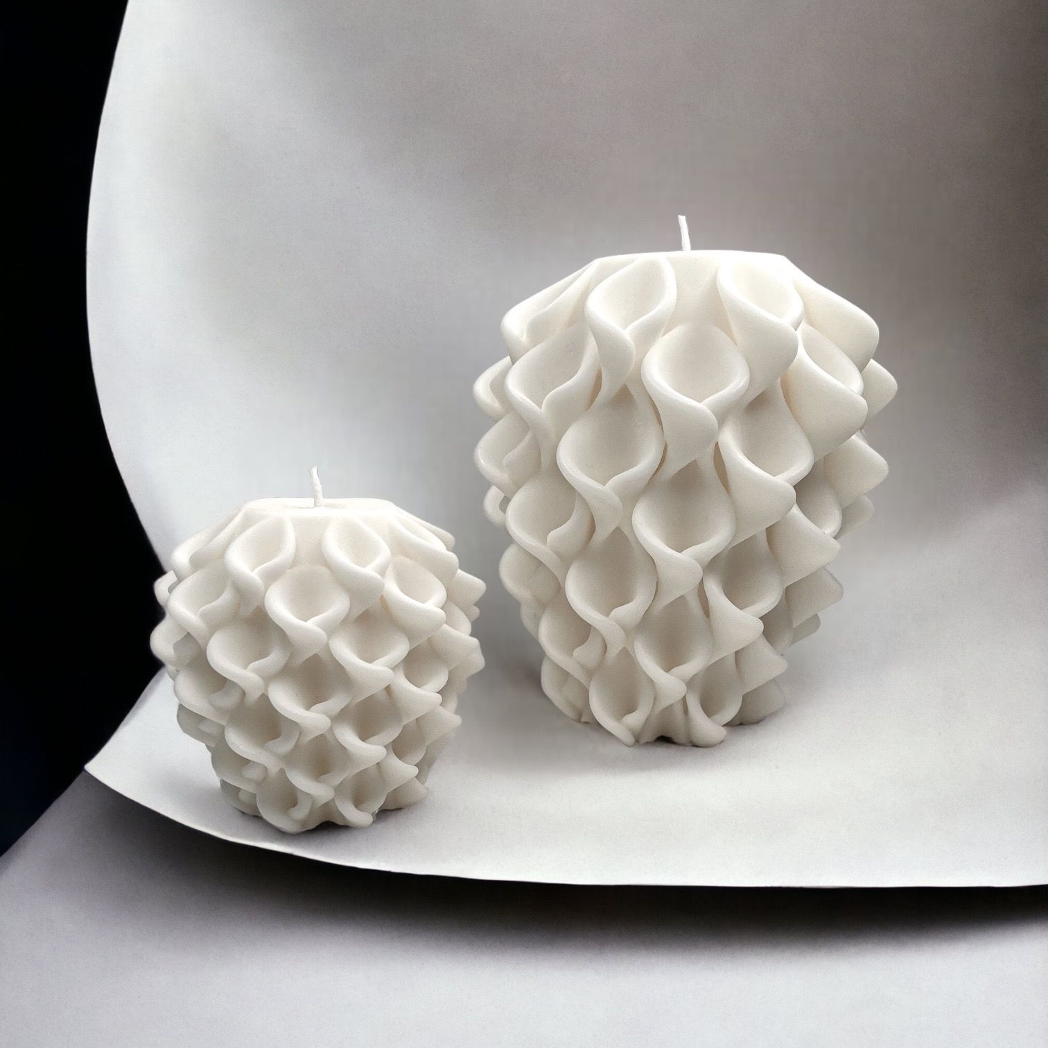 Twee witte kaarsen staan ​​op een stuk papier