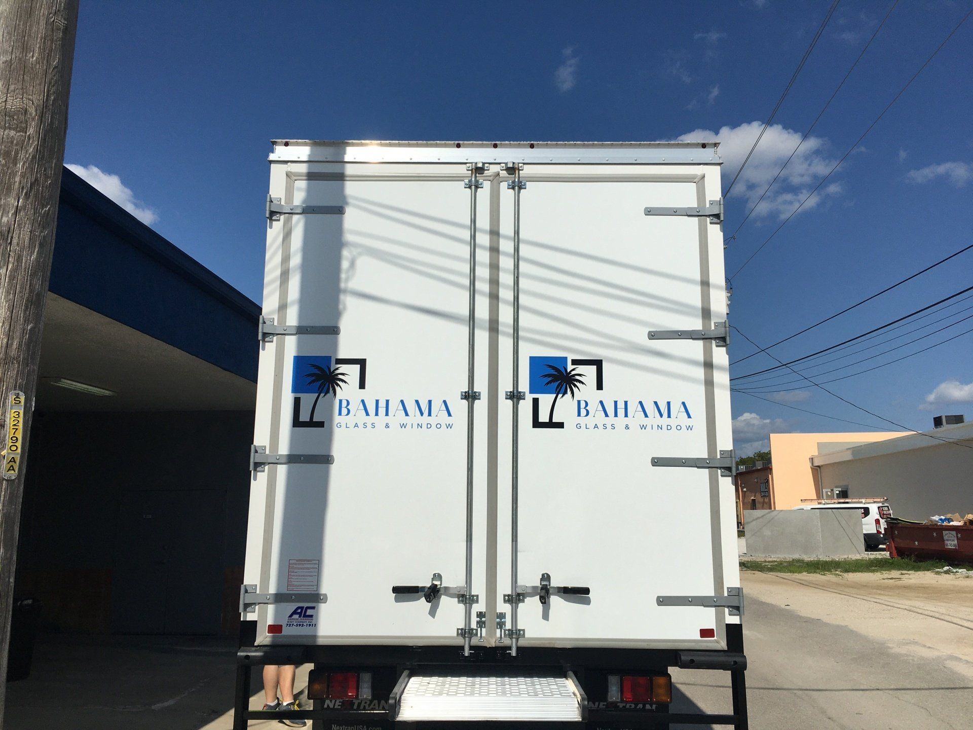 Rear view of a white delivery truck with 